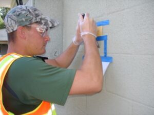 a man painting the outside of a building