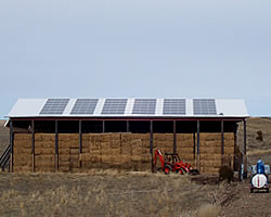 outside of a barn with solar panels on the roof